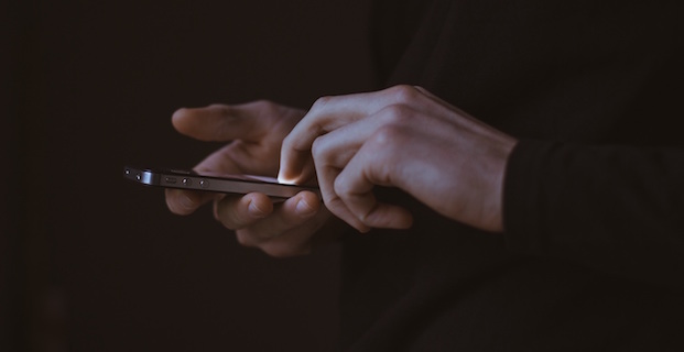 Hands using cellphone to send your message